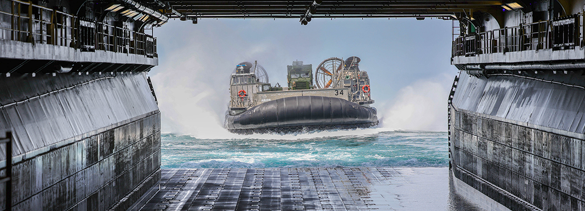  Landing Craft Air Cushion 34 approaches the well deck of the Wasp-class amphibious assault ship USS Iwo Jima (LHD 7) to dock and unload equipment.